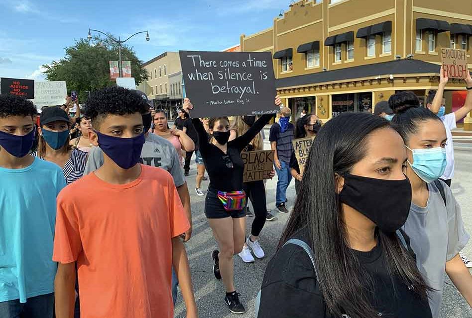 Police and protesters march side by side in Kissimmee vowing to end racial violence, and seek justice