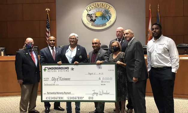 Underground Refuse Systems presents Kissimmee Commissioners with $10,000 partnership/warranty payment