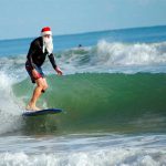 A Coastal Christmas Eve Morning Tradition: The Surfing Santas of Cocoa Beach