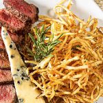 Tropical Elegance: Teres Major Steak with Shoestring Potatoes & Gorgonzola